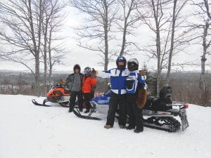 Bundled up against the cold, these riders were part of the 11th annual Snowarama for Easter Seals in Grand Portage on Saturday, February 8, 2014. There are many scenic spots along the trails like this one. See more about Snowarama on page A3.