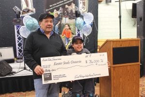 Everyone enjoyed the delicious banquet at the end of a day of riding in the Snowarama for Easter Seals on Saturday, February 8. After dinner, it was revealed that riders had raised $36,000 for Easter Seals of Ontario. Grand Portage Tribal Chair Norman Deschampe was happy to help Easter Seals Ambassador Zachary Pylychuk hold the big check celebrating the 2014 total.