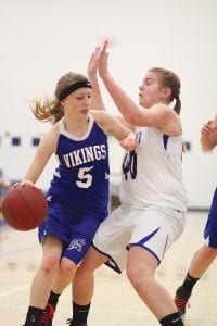 Above: With the Cromwell defender getting a little too close, Suzy Burton put her arm out to give herself some space as she dribbled around her defender to get to the basket. Left: With her eyes on the basket, Shauna Blake takes a shot against the Carlton Bulldogs. Blake scored four points against the Bulldogs in the Vikings win.