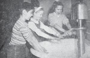 Among other amenities, students at the new Birch Grove School in Tofte tried out the new hand washer on the first day of classes, Feb. 10, 1964. From left are Tommy Parent, Jacque Bierbaum and Sheila Skou. How does it work? A foot control is depressed to keep both hands free when washing. The children enjoyed this task immensely!