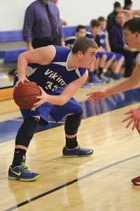 Jamie Wick gets ready to school his defender. Wick scored 8 points against Lakeview Christian and pulled down 4 rebounds in the Vikings' tough loss to the Lions.