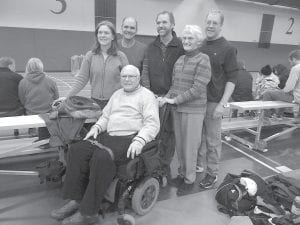 Gene Glader’s family was happy to pose with the guest of honor (front) at the first annual Gene Glader Classic indoor track meet at Bethel College. (L-R) Glader’s children Sonja, Tim, and Tom, wife Laurene and son-in-law Scott Langie.