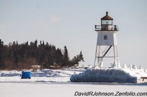 Although fish houses on the ice are a common sight in the Duluth harbor, it is rare to see an ice shelter set up in the Grand Marais harbor. This picture shows the extent of this winter’s weather on the ice of Lake Superior. Photographer David R. Johnson took a photo of this fisherman’s temporary shelter—from far away on solid ground.