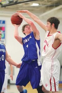 Junior guard Richie Furlong busted through the lane for 2 points on this play against the Silver Bay Mariners. Not a big scorer, Furlong did all of the small things right this season, setting picks, fighting for every loose ball, playing tenacious defense, and making good passes.