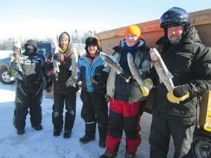 Despite bitter cold temperatures, people turned out to fish in the Cook County Ridge Riders Trout Derby on Sunday, March 2. A total of six fish were caught. (L-R) Catching the largest fish at 5.77 pounds and winning $500 cash was Matt Packer. In second place, winning an ice auger donated by Mike’s Holiday, was Dave Plummer with a 5.07-pound lake trout. James “Sporto” Ford won third place with a 3.21-pound trout. His prize was a barbecue grill donated by Buck’s Hardware Hank. Next is Wyatt Baker with his 2.93-pound walleye and Bob Baker holding the fish he caught—a 3.10-ounce trout as well as his son Jaret’s fish, a 1.63-ounce trout.