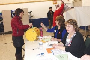 The township of Tofte had a high turnout for its election with 60 ballots cast. Election Judges Julie Rannetsberger (left) and Tammy Rude assist a voter. Not pictured is their fellow judge Diane Norman.