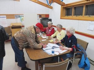 Schroeder Election Judges (L-R) Judy Gregg, Carol Tveekrem and Jan Dillon help a voter sign in during the township election on Tuesday, March 11, 2014.