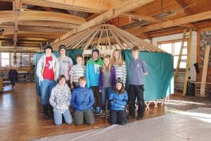 Great Expectations School eighth-graders pause in their yurt construction for a photo. (L-R, front) Karl Bottorff, Andy Kern, Nina Woerheide. (L-R, back) Klaus Bottorff, David Blackburn, Noah Works, Cedric Rock, Linnea Henrikson, Lucy Callender, Finn Garry.