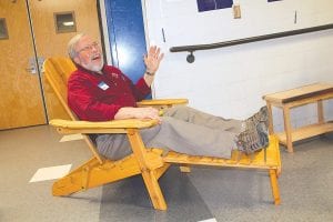 There were some fabulous items on the E.A.T.S. silent auction like this Adirondack chair. Craig Peterson gives it a try.