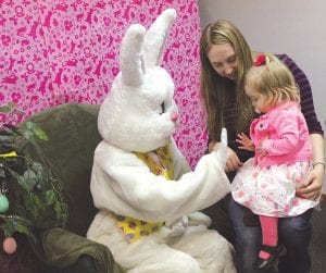 The Easter celebration at the Cook County Community Center on Saturday, April 19 was lots of fun. Above: Christine Donnell tries to convince her daughter Aviva that the Easter Bunny is not scary. Right: Little Lily was one of the hardy kids who searched for candy-filled eggs in the spring blizzard.