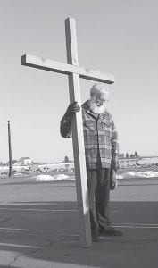 Community members gathered for the annual Crosswalk procession on Good Friday, April 18. About 30 people followed the cross from church to church in Grand Marais, offering prayers for those churches, as well as those on the east and west ends of the county. Left: Father Seamus Walsh of St. John’s Catholic Church in prayer. Pastors and parishioners from various churches took turns bearing the cross.