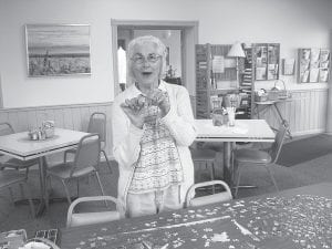 Above: Marion Pearson of Hovland, working the alwayspresent jigsaw puzzle. Left: Betty Wilson was the lucky winner of our Easter Bingo coverall. She is pictured here with her prize, a wonderful pie donated by The Pie Place.