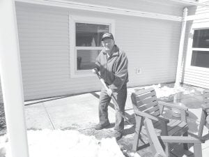 North Shore Care Center resident Don Sorlie pitched in and shoveled snow from the Care Center patio on Earth Day, April 22.