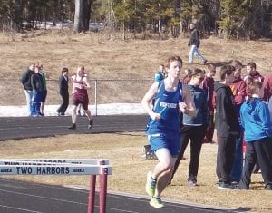 The Cook County track team has been seen running all over Cook County in all kinds of weather. They participated in a meet at Two Harbors on Tuesday, April 22. Above: Roman Schnobrich in the boys’ 4x800-meter relay team at the Two Harbors Invitational. Left: Leif Anderson also participated in the boys’ 4x800 meter relay team at the Two Harbors Invitational. The boys placed third in the relay. Schnobrich also ran the open 800 meters, finishing in 2:40, while Anderson, just a seventh-grader, ran the open 1,600 meter (one mile) run in 5:37.