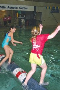 Far left: Riley Goettl (left) concentrates on her competitor’s feet as the log spins rapidly.