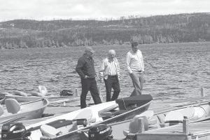 Congressman Jim Oberstar walked the talk. Over Memorial Day weekend 2007, Congressman Oberstar toured Cook County, seeing for himself the devastation of the Ham Lake wildfire. With the scorched hillside on the north side of Gunflint Lake in the background, Oberstar visited with Bruce Kerfoot (left) and Lee Kerfoot about getting help in restoring telephone service to the Gunflint Trail.