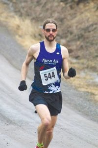 Above left: Mark Maronese of Thunder Bay (554) bested the men’s field by more than 10 minutes. Above right: A smiling Kerrie Berg (664) seems unaffected by the cold weather. Berg finished 3rd in the women’s race.