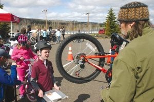 Mark Spinler checked Noah Haussner’s bicycle for any problems at the Bike Rodeo held on Tuesday, May 13. Spinler is the owner/operator of Superior North Outdoor Center bicycle shop in Grand Marais and he and his staff were on hand to instruct and help young riders learn about bicycle maintenance and to give safe riding tips. See more of the Bike Rodeo on page B6.