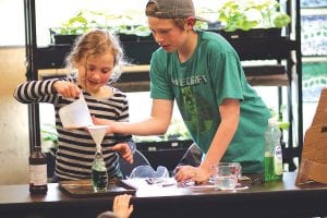 Above: The Great Expectations School Science Fair was held May 6 and there were fascinating experiments to see. Sibling scientists Grace and Lyndon Blomberg made “elephant tooth paste,” a fun, foamy concoction.