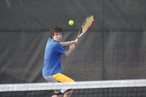 At the net, Jerod Spry (above) gets ready to hit the ball into the backcourt; Pete Summers (left) shows off his two-fisted backhand in a recent match against Marshall.