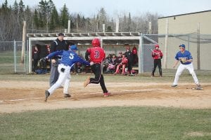 Above: Viking catcher Richie Furlong chased No. 3 almost to third base before flipping the ball to Jack Weiben who made the tag for the out. Frankie Miller, meanwhile, covered home plate for the Vikings. Far left: Hard-hitting Joe Borud pounded the ball up the middle for a single in this at bat. Left: Leo Johnson delivers a strike against the Two Harbors Agates on this pitch.