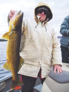 Cold weather does not deter Gunflint Trail resident Larry Schei of Loon Lake from fishing. Larry caught this spawned out 30-inch walleye on Wednesday, May 14, 2014. Larry was fishing with his wife Sue, and his son, Gunflint Lodge guide, Jon Schei.