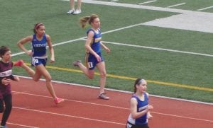 Above: Smooth striding Molly Thomas (2) qualified for the Section 7A track meet in the 400-meter run with a time of 65.52 seconds. Left: Maya McHugh (6) qualified for the Section meet in the 3200-meter (2 mile) run with a time of 13:35. Like most of the track team Maya, an eighth grader and Molly, a ninth grader, are young. A top two finish at Sections will qualify them for the state track meet held in early June.