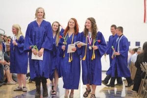 Above: Happy graduates! (L-R) Cedar Adams, Suzy Burton, Sophie Honeder and Salutatorian Audrey Summers. Far left: Math Instructor Tim Dennison was an inspiring—and very funny—guest speaker. Left: Principal Gwen Carman presented her daughter Anna’s diploma along with a happy hug.