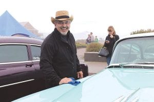 Left: Keeping the beautiful cars dry was a losing battle, but Ozzie DiStefano of Thunder Bay didn’t seem to mind as he polished his 1956 Cadillac Sedan DeVille.