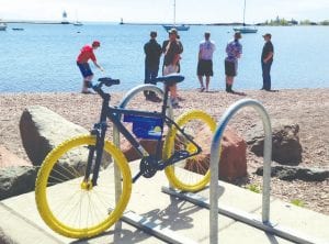 The Moving Matters group and the Grand Marais Recreation Park have worked together to create some “Billboard Bikes.” The bright blue and yellow bikes have been placed on bike racks around town to call attention to the location of those racks, as well as to demonstrate the proper way to attach your bike.