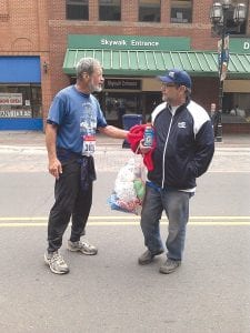 Above: Jan Horak of Tofte stopped on his way to finishing his 25th Grandma's Marathon to say hi to Grandma's volunteer Brian Larsen. Horak walked the distance in 6 hours and 17 minutes, saying he didn’t have one cramp along the way.