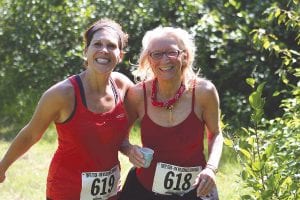 Smiling as they finish together were Monica Christiansen (619) and LaVonne Christiansen (618).