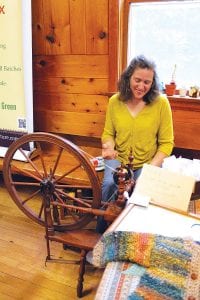 The Hovland Town Hall was the place to be for art lovers on the 4th of July weekend. Left: Patty Meyer spins fiber to make yarn on a spinning wheel that belonged to her great-grandmother. Above: Shoppers had a hard time deciding which lovely item to purchase from all of the artistic offerings, like these lovely Terry Lewis painted glass pieces.