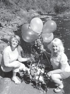 The West End Garden Club Flower Show Co-Chairs Anita Smith (left) and Phyllis Miron prepare to “launch” a bouquet. Look for many beautiful bouquets in the July 19 show Around the World in 80 Bouquets.