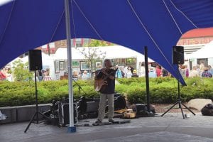 Downtown Grand Marais was bustling with activity during the Grand Marais Arts Festival on July 12 -13, 2014. Michael Monroe performed under the big blue tent in Harbor Park as artists worked and shoppers shopped at the 70 tents at the arts festival.