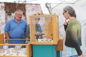 Myra Theimer of Grand Marais considers a purchase of jewelry from Kristine Danielson. Danielson finds the inspiration for her jewelry in nature.