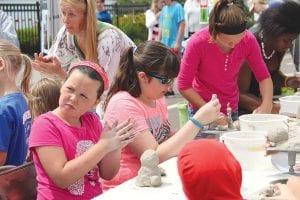 There were some great activities for kids at the arts festival, such as creating clay characters.