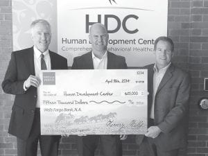 HDC’s Executive Director Jim Getchell (left) accepts the check from Matt Cochran, Wells Fargo Business Relations Manager (center) and Scott Bradt, Wells Fargo Business Banking President for Duluth.