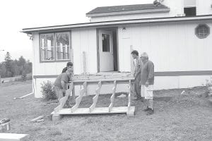 There was a flurry of activity at the Life in Christ Lutheran Church in Grand Marais last weekend as volunteers from the Cross View Lutheran Church in Edina came to help with renovation of the buildings purchased in May. One of the most pressing issues was replacing the rickety deck and steps.