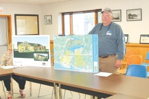 Tofte Supervisors Paul James and Jim King attended the Tuesday, July 8, 2014 meeting of the Cook County/ Grand Marais Economic Development Authority (EDA) to share their plans to construct a 12-unit senior housing development on land in Tofte just behind the Birch Grove Community Center. Supervisor James, pictured here with a map of the proposed development area and an architect’s rendering of what the housing could look like, said he recognized the need for senior housing 10 years ago because of his grandmother. He said she had to leave the community because there was no place for her to live. For the last four years the township has worked doggedly to create senior housing in the community. Supervisor King told the EDA that Tofte was not asking for money, just a vote of confidence as the township seeks funding from other sources. The EDA board passed a unanimous motion of support for the Tofte project.