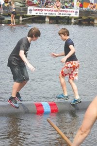 Dominick Wilson looks confident as he works to get his competitor to take a plunge into the Namekagon River. He was successful!