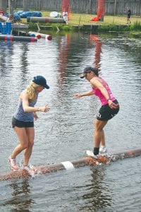 Above: Log rolling coach and mentor Jenny Atkinson (right) won 3 matches and placed just outside of the money in a stacked field of women rollers at the Namekagon River Roll-Off. Right: Jessica Berg-Collman (right) did well in her first professional log rolling tournament of the year. Berg-Collman won two matches and lost two matches in the Namekagon River Roll-Off held in Hayward, Wisconsin on Sunday, July 20.