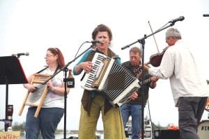 Above left: After the Parade of Teams, The Splinters took the stage for an evening of their eclectic mix of folk, swing and zydeco. Above right: The Splinters got everyone –including these ladies from the Nokomis Dragon Slayers—up and dancing.