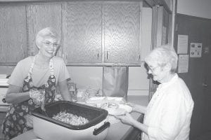 The First Congregational Church – United Church of Christ once again hosted a Shrimp Boil on Friday, August 1 during Fisherman’s Picnic. Left: Nancy Strayer serves up some delicious shrimp for Carol Harris. Above: “Bear” Cihlar stirs the boiling shrimp. The shrimp comes to the North Shore from the Back Bay Mission in Biloxi, Mississippi and proceeds from the event are returned to the sister church.