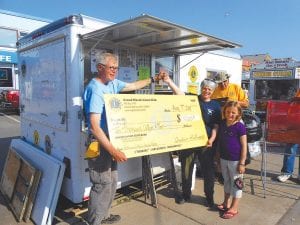 And the winner is…EvaLyn Carlson of Grand Marais was the lucky winner of the Grand Marais Lions Club $10,000 raffle. She brought along a young friend, RaeAnne Silence, who she said was her “lucky charm” when she accepted the big check from Grand Marais Lion—and 2014 Citizen of the Year—Mike Carlson. See more Fisherman’s Picnic news throughout the paper.