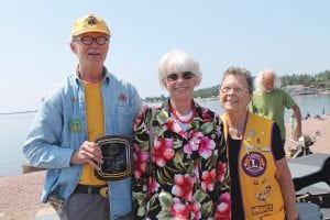 Mike and Nancy Carlson pose with Lion Rosemary after they received the plaque recognizing them as Cook County Citizens of the Year.