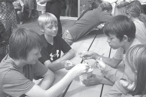 Clockwise from left: With spoons poised and eyes fixated on their 32-ounce Dairy Queen Blizard, Sammy Sietsema, Luke Johnson, Dominick Wilson and Molly Sietsema get ready to compete in the blizzard eating contest.