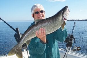 Robert Moore from Dayton, Ohio had a great day of fishing with Captain Darren Peck of Tofte Charters on July 23. He shows off his 14-pound lake trout.