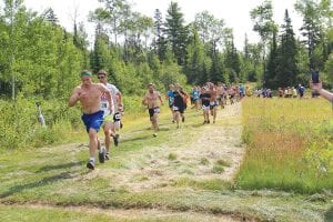 Upper Left: The field quickly spread out at the start of the 5-mile Fisherman’s Picnic trail race. Left: Looking amazingly fit, Kieran Scannell (321) and Ailee Larson both easily ran away from their competition to win individual titles. Above: The kids' race is always a fan favorite. These little runners showed little regard for pacing, running all out until they were exhausted.