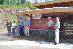 The Ray Berglund State Wayside has always been a lovely little stop on Highway 61, but enhancements completed in the last year have made it even nicer. Taking part in a ribbon cutting on July 31, 2014 were (L-R) Lori Dowling-Hanson, Minnesota Department of Natural Resources (DNR) Northeast regional director; Erika Rivers, DNR Parks and Trails director, Doris Berglund, Ken Berglund, Tom Landwehr, DNR commissioner, Jason Peterson, Tettegouche State Park manager and Mark Kovacovich, DNR Parks and Trails district manager.